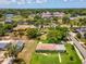 The aerial shot features a single-Gathering home with a sprawling lawn, close to schools and recreational areas at 6823 Oak Hill Dr, New Port Richey, FL 34653