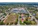 An aerial shot features a single-Gathering home with a lawn near commercial buildings, convenient for work and amenities at 6823 Oak Hill Dr, New Port Richey, FL 34653