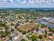 Aerial view of a residential home with lush landscaping, a nearby parking lot, and easy access to nearby amenities at 6823 Oak Hill Dr, New Port Richey, FL 34653