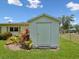 Backyard shed for extra storage with nice landscaping and a lush green lawn at 6823 Oak Hill Dr, New Port Richey, FL 34653