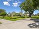 A landscaped yard surrounds this ranch-style home with flowering shrubs and a mature shade tree at 6823 Oak Hill Dr, New Port Richey, FL 34653