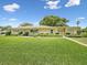 Charming single-story home with a well-manicured lawn, mature trees, and inviting curb appeal at 6823 Oak Hill Dr, New Port Richey, FL 34653