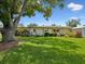 Charming single-story home featuring a lush green lawn, mature trees, and well-maintained landscaping, boosting curb appeal at 6823 Oak Hill Dr, New Port Richey, FL 34653