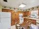 Traditional kitchen features wood cabinetry, tile countertops, and a breakfast table at 6823 Oak Hill Dr, New Port Richey, FL 34653
