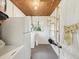 Functional laundry area with white appliances, open shelving, and a wooden plank ceiling, creating a practical workspace at 6823 Oak Hill Dr, New Port Richey, FL 34653
