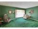 Relaxing living room with green accents, classic furnishings, and a bright window at 6823 Oak Hill Dr, New Port Richey, FL 34653