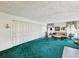 Inviting living room featuring a plush green carpet, large closet storage, and comfortable seating area at 6823 Oak Hill Dr, New Port Richey, FL 34653