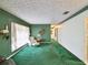 Cozy living room with green accents, a comfortable armchair, and ample natural light at 6823 Oak Hill Dr, New Port Richey, FL 34653