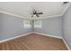 Bright bedroom with wood flooring, ceiling fan, and two windows offering natural light at 6989 300 Th N Ave, Clearwater, FL 33761