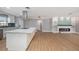 Bright open concept with spacious kitchen island, modern appliances, and fireplace-centered living area at 6989 300 Th N Ave, Clearwater, FL 33761