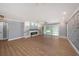 Bright open living room featuring wood floors, a modern fireplace, custom shelving, and sliding glass doors at 6989 300 Th N Ave, Clearwater, FL 33761
