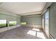 Enclosed sunroom with tiled floors and multiple windows, perfect for enjoying natural light at 6989 300 Th N Ave, Clearwater, FL 33761