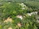 Aerial view featuring a house surrounded by a dense forest of trees and greenery at 7340 20Th, Zephyrhills, FL 33540