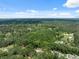 Stunning aerial view of a lush green landscape featuring scattered residences at 7340 20Th, Zephyrhills, FL 33540