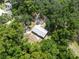 Aerial view of a charming home surrounded by dense, green trees at 7340 20Th, Zephyrhills, FL 33540