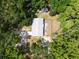 Overhead shot of property featuring main house, driveway, fenced area, and mature trees at 7340 20Th, Zephyrhills, FL 33540