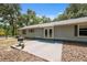 This charming home features a quaint backyard with a small patio area and mature trees at 7340 20Th, Zephyrhills, FL 33540