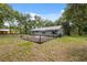 The backyard is fully fenced and features a well-maintained lawn and a small patio area at 7340 20Th, Zephyrhills, FL 33540