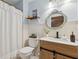 Charming bathroom with vanity, decorative mirror, and shower with curtain at 7340 20Th, Zephyrhills, FL 33540