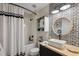 Stylish bathroom featuring decorative black and white tiling, a vanity, and a shower with a curtain at 7340 20Th, Zephyrhills, FL 33540