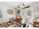 Dining room with white chairs and an industrial-style light fixture at 7340 20Th, Zephyrhills, FL 33540