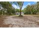 Quaint home on a sprawling lot, framed by lush trees, and a long driveway at 7340 20Th, Zephyrhills, FL 33540