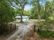 Charming home with well-maintained landscaping, viewed from the gated entrance at 7340 20Th, Zephyrhills, FL 33540