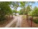 View of the house from behind an entrance gate, showcasing its curb appeal at 7340 20Th, Zephyrhills, FL 33540