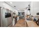 Bright kitchen features white cabinets, stainless steel appliances, and wood-look flooring at 7340 20Th, Zephyrhills, FL 33540