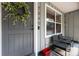 Close up of the front porch showing seating and decorative wreath at 7340 20Th, Zephyrhills, FL 33540