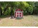 A rustic shed with red siding and white trim, providing ample storage space at 7340 20Th, Zephyrhills, FL 33540