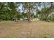 Expansive yard with mature trees, providing a serene and private setting for the home at 7340 20Th, Zephyrhills, FL 33540