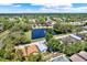 Neighborhood aerial view highlighting a pond with a fountain and well-spaced homes with mature trees at 7736 Chadwick Dr, New Port Richey, FL 34654
