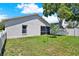 Spacious backyard features lush green lawn and white fence, offering a serene outdoor space at 7736 Chadwick Dr, New Port Richey, FL 34654