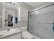 Bathroom with a toilet, sink and sliding shower door at 7736 Chadwick Dr, New Port Richey, FL 34654