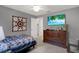 Bedroom with a TV, patterned quilt, and dresser with drawers at 7736 Chadwick Dr, New Port Richey, FL 34654
