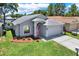 Aerial view of a beautifully landscaped home showcasing curb appeal and a well-manicured lawn at 7736 Chadwick Dr, New Port Richey, FL 34654