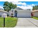 Charming single-story home featuring a two-car garage, well-kept lawn, and welcoming curb appeal at 7736 Chadwick Dr, New Port Richey, FL 34654