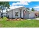 Charming single-Gathering home with beautiful landscaping, a manicured lawn and a welcoming entrance at 7736 Chadwick Dr, New Port Richey, FL 34654