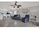 Cozy living room with tile flooring, ceiling fan, and comfortable seating, open to the kitchen at 7736 Chadwick Dr, New Port Richey, FL 34654