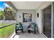 Cozy screened patio with tile flooring, ceiling fan, and outdoor furniture overlooking the lush backyard at 7736 Chadwick Dr, New Port Richey, FL 34654