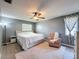 Comfortable bedroom featuring a ceiling fan, soft lighting, and neutral tones at 7979 Avenal Loop, New Port Richey, FL 34655