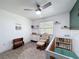 Bright Bedroom room featuring a modern gray flooring and a crib at 7979 Avenal Loop, New Port Richey, FL 34655