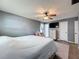Spacious bedroom with fan, and gray walls at 7979 Avenal Loop, New Port Richey, FL 34655