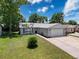 Charming single-story home featuring a well-maintained lawn and attached two car garage at 7979 Avenal Loop, New Port Richey, FL 34655