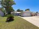Well-maintained home featuring a green lawn and attached garage at 7979 Avenal Loop, New Port Richey, FL 34655