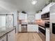 Modern kitchen featuring stainless steel appliances, granite counters, and updated fixtures at 7979 Avenal Loop, New Port Richey, FL 34655