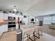 Well-lit kitchen boasting stainless steel appliances, granite countertops, and an island with seating at 7979 Avenal Loop, New Port Richey, FL 34655