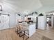 Bright kitchen with stainless steel appliances, an island with bar seating, and white cabinetry at 7979 Avenal Loop, New Port Richey, FL 34655