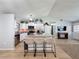 Stylish kitchen with granite counters, stainless appliances, and an island with barstool seating at 7979 Avenal Loop, New Port Richey, FL 34655